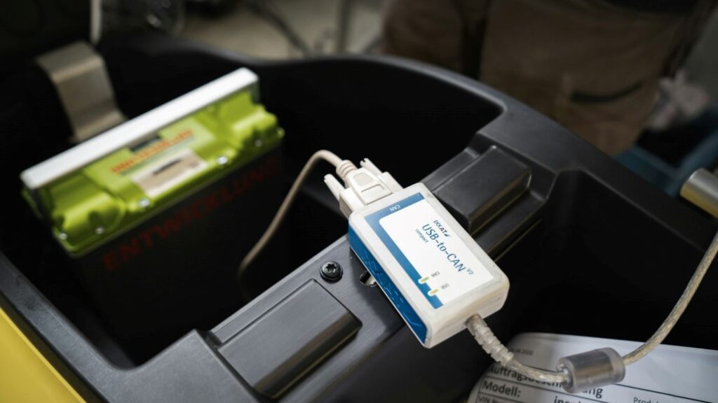 Electric scooter removable battery with diagnostic USB-to-CAN device connected